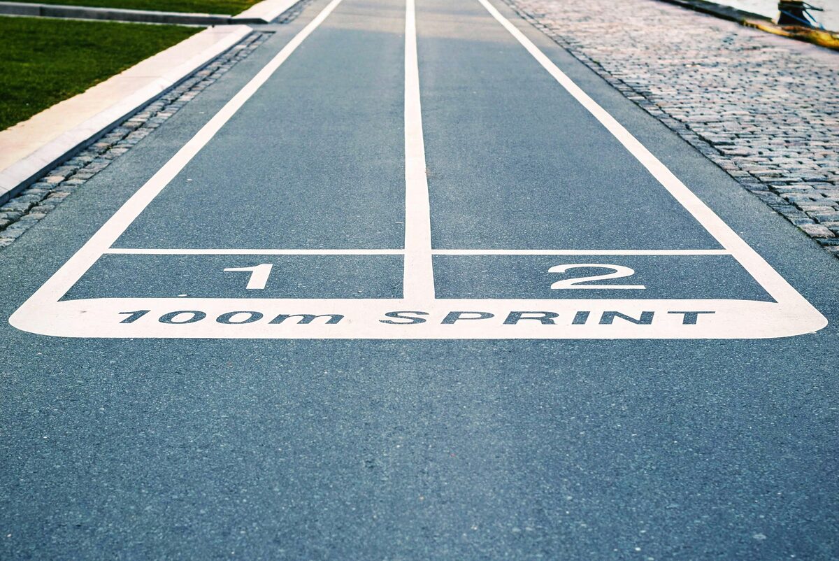 Close-up of outdoor 100m sprint track lanes, perfect for athletics and sprinting events.